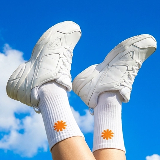 White socks with an orange Create asterisk against a blue sky